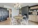Cozy dining area featuring a wooden table, decorative lighting, a fireplace, and seamless flow into other living spaces at 8320 E Monte Vista Rd, Scottsdale, AZ 85257