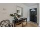 Stylish entryway featuring modern console table, mirror, and view into the kitchen at 8320 E Monte Vista Rd, Scottsdale, AZ 85257