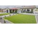 Attractive home exterior with fresh green lawn, bougainvillea, and modern landscaping at 8320 E Monte Vista Rd, Scottsdale, AZ 85257