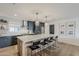 Modern kitchen featuring a large island with bar seating, stainless steel appliances, and stylish pendant lighting at 8320 E Monte Vista Rd, Scottsdale, AZ 85257