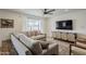 Cozy living room showcasing a large sectional couch, media center, and bright window at 8320 E Monte Vista Rd, Scottsdale, AZ 85257