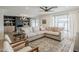 Bright living room with a large sectional couch, ceiling fan, and ample natural light from the large windows at 8320 E Monte Vista Rd, Scottsdale, AZ 85257