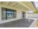 The covered patio has a brick floor, glass sliding doors, and a large window to allow plenty of natural light at 8320 E Monte Vista Rd, Scottsdale, AZ 85257
