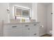 Modern bathroom featuring double sinks, ample cabinet space and a backlit mirror at 8326 E Crestwood Way, Scottsdale, AZ 85250
