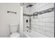 Modern bathroom featuring tiled walls, rainfall shower head, and sleek fixtures at 8326 E Crestwood Way, Scottsdale, AZ 85250