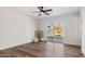 Bright bedroom with hardwood floors, ceiling fan, and sliding glass door to the backyard at 8326 E Crestwood Way, Scottsdale, AZ 85250