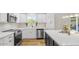 The recently renovated kitchen offers stainless appliances, white cabinets, and sleek countertops at 8326 E Crestwood Way, Scottsdale, AZ 85250