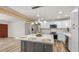 Inviting open-concept kitchen featuring a large island, white cabinets, and stainless appliances at 8326 E Crestwood Way, Scottsdale, AZ 85250