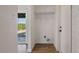 Laundry room featuring brick walls, shelving, and door to backyard at 8326 E Crestwood Way, Scottsdale, AZ 85250