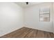 Clean bedroom space featuring wood-look floors, neutral paint, and a bright window at 8541 W Malapai Dr, Peoria, AZ 85345
