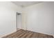 Bright bedroom with wood-look floors, neutral walls, and an open door at 8541 W Malapai Dr, Peoria, AZ 85345