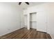 A light filled bedroom with hardwood floors and a closet with sliding doors at 8541 W Malapai Dr, Peoria, AZ 85345