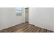 Well-lit bedroom with a window, closet and beautiful wood flooring at 8541 W Malapai Dr, Peoria, AZ 85345