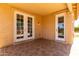 Covered patio featuring elegant french doors and an additional entry door leading to the yard at 8541 W Malapai Dr, Peoria, AZ 85345