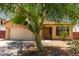 Charming single-story home with desert landscaping and a well-maintained front yard and a large shady tree at 8541 W Malapai Dr, Peoria, AZ 85345