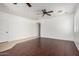 Spacious living room featuring hardwood floors, natural lighting, and a ceiling fan at 8541 W Malapai Dr, Peoria, AZ 85345