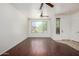 Bright living room with wood floors, large window, ceiling fan, and neutral walls at 8541 W Malapai Dr, Peoria, AZ 85345