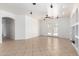 Living room showing tile flooring, ceiling fan, backyard access, built in shelves, and neutral walls at 8541 W Malapai Dr, Peoria, AZ 85345