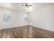 Bedroom with wood floors, two windows, and a glass door to backyard at 8541 W Malapai Dr, Peoria, AZ 85345