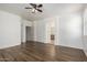 Bedroom with wood floors, ceiling fan and attached bathroom at 8541 W Malapai Dr, Peoria, AZ 85345