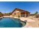Private backyard pool featuring beautiful desert landscaping and home exterior at 8541 W Malapai Dr, Peoria, AZ 85345