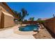 Gorgeous pool featuring a rock waterfall, mature landscaping, and adjacent patio at 8541 W Malapai Dr, Peoria, AZ 85345