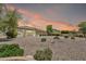Large backyard with desert landscaping, mature trees, and a covered patio at 9225 W Bajada Rd, Peoria, AZ 85383
