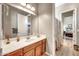 Bathroom with vanity, mirror, decor and doorway leading to a bedroom at 9225 W Bajada Rd, Peoria, AZ 85383