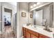 Bathroom with vanity, mirror, decor and doorway leading to another room at 9225 W Bajada Rd, Peoria, AZ 85383