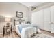 Bright bedroom features a bed, side table and large mirrored closet at 9225 W Bajada Rd, Peoria, AZ 85383
