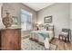 Bedroom features a cozy bed and side table; neutral paint and decor at 9225 W Bajada Rd, Peoria, AZ 85383