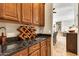 Butler's pantry with wine rack, cabinets, and dark countertops at 9225 W Bajada Rd, Peoria, AZ 85383