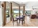 Bright dining area featuring large windows, comfortable seating, and views of the landscaped backyard at 9225 W Bajada Rd, Peoria, AZ 85383