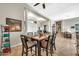 Dining area features a wooden table with seating for six, tile floors, and columns and lighting fixtures at 9225 W Bajada Rd, Peoria, AZ 85383