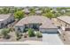 Aerial view of a well-manicured house featuring lush landscaping, stone accents, and a three-car garage at 9225 W Bajada Rd, Peoria, AZ 85383