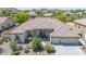 Beautiful single-story home features a tile roof, stone accents, manicured landscaping, and a three-car garage at 9225 W Bajada Rd, Peoria, AZ 85383