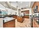 Kitchen with dark countertops, island, stainless steel appliances, and seamless transition to dining area at 9225 W Bajada Rd, Peoria, AZ 85383
