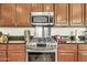 Kitchen with stainless steel appliances, granite countertops, and wood cabinets at 9225 W Bajada Rd, Peoria, AZ 85383
