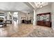 Spacious living room with tile floors, neutral walls, columns, ceiling fan and large windows with natural light at 9225 W Bajada Rd, Peoria, AZ 85383