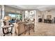 Bright living room with tile floors, neutral walls, comfortable seating, and open access to the dining area and patio at 9225 W Bajada Rd, Peoria, AZ 85383
