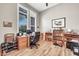 Cozy office space with wood floors, a desk, shelves, plantation shutters and natural light at 9225 W Bajada Rd, Peoria, AZ 85383