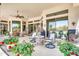 Covered patio with ceiling fan, seating, grill and beautiful red flowers at 9225 W Bajada Rd, Peoria, AZ 85383
