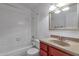 Bathroom with white tile surround, shower and bathtub combination, and sink with vanity at 9601 S 44Th St, Phoenix, AZ 85044