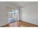 Bright dining area features tile flooring, a modern light fixture, and sliding glass door leading to the patio at 9601 S 44Th St, Phoenix, AZ 85044