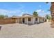 Exterior view of home and covered patio with desert landscaping and block wall fencing at 9601 S 44Th St, Phoenix, AZ 85044