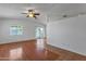 Living room with vaulted ceiling, wood floors, and sliding glass door to the backyard at 9601 S 44Th St, Phoenix, AZ 85044