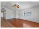 Living room with wood floors, neutral paint, and a ceiling fan with attached light fixture at 9601 S 44Th St, Phoenix, AZ 85044