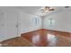 Living room with hardwood flooring, a ceiling fan, and a well-lit interior at 9601 S 44Th St, Phoenix, AZ 85044