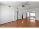 Spacious main bedroom with wood floors, ceiling fan, closet, and ensuite bathroom at 9601 S 44Th St, Phoenix, AZ 85044