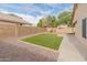 Well-maintained backyard featuring an artificial lawn, gravel landscaping, and a charming pergola at 10226 N 93Rd Dr, Peoria, AZ 85345